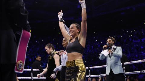 Chantelle Cameron celebrates with Katie Taylor hanging her head