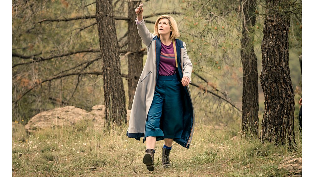 BBC Studios The rainbow stripes, cropped trousers and clompy boots of Jodie Whittaker's ensemble was in opposition to the previous Doctor's look (Credit: BBC Studios)