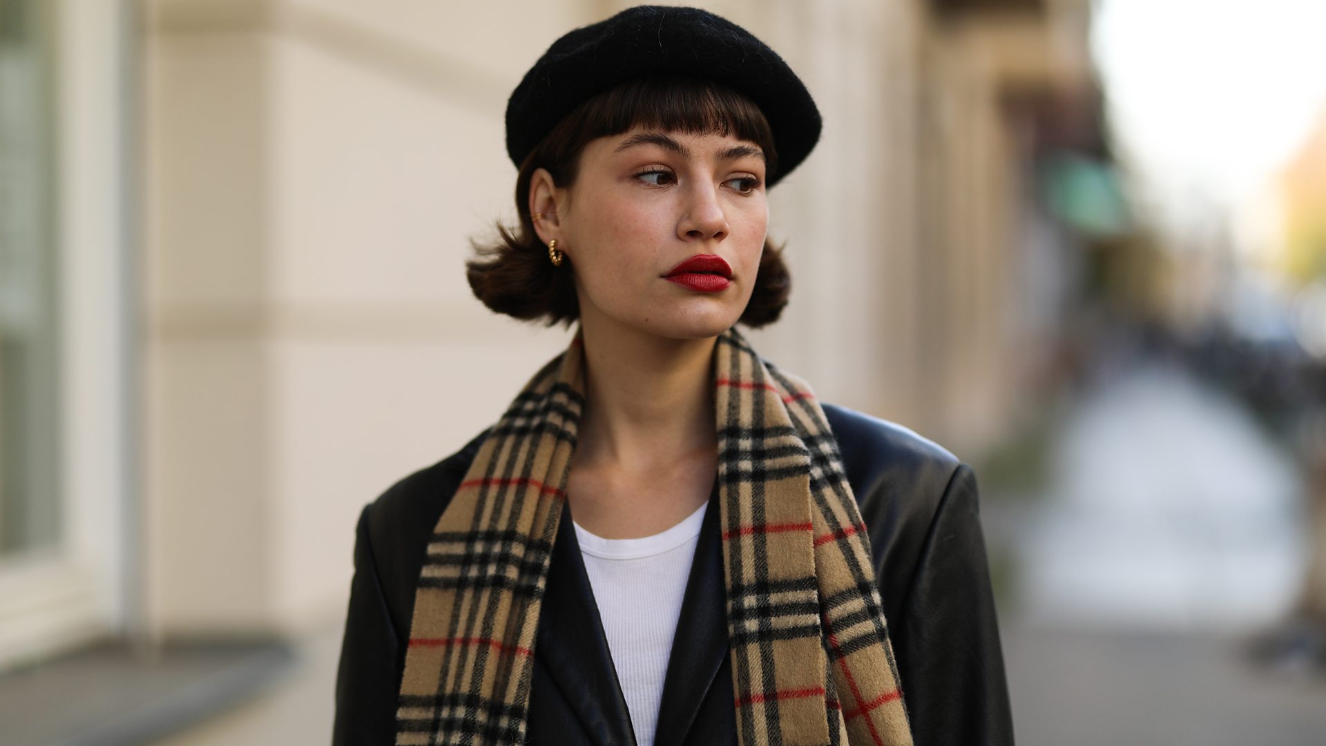 Street style shot of model in vintage beret and coat